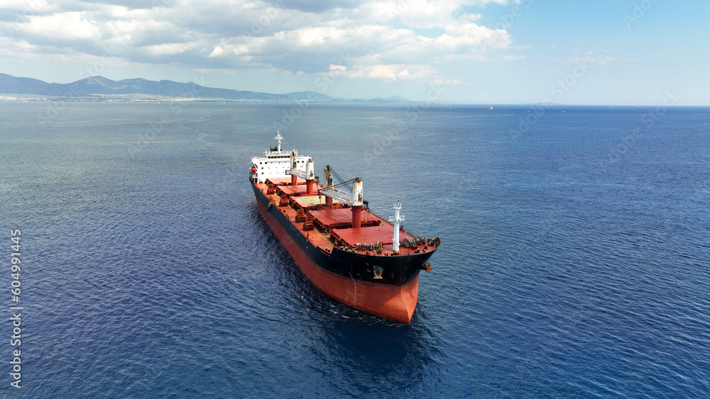 Aerial drone photo of huge industrial bulk carrier tanker anchored in deep blue Aegean sea