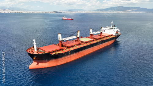 Aerial drone photo of huge bulk carrier tanker anchored in deep blue Aegean sea