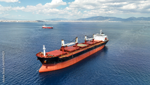 Aerial drone photo of huge industrial bulk carrier tanker anchored in deep blue Aegean sea