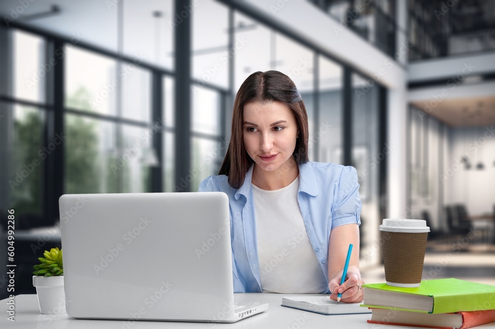 Young happy business woman using laptop,
