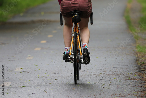 Fototapeta Naklejka Na Ścianę i Meble -  Young sport woman riding bicycle in the morning in public bike way