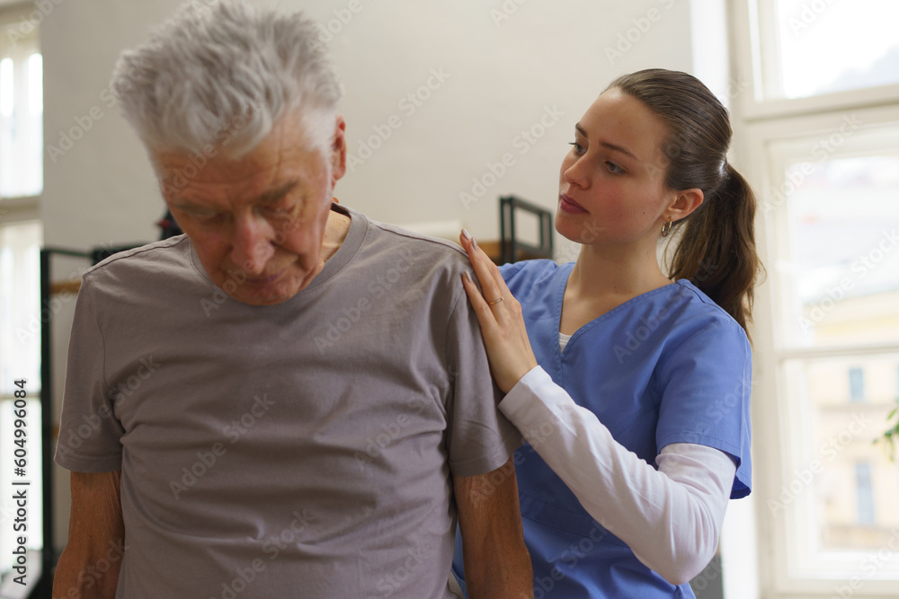 Young nurse doing exercise with senior man. Young nurse doing exercise with senior man.
