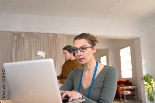 Fashion designer working with computer in design studio
