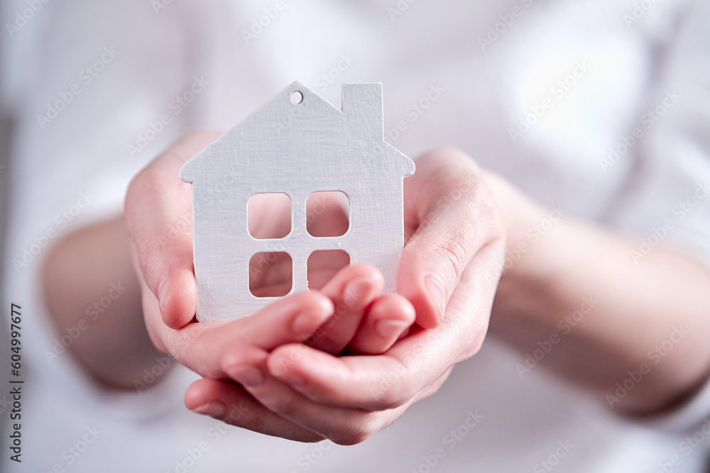 Real estate agent holding house model Real estate agent holding house model