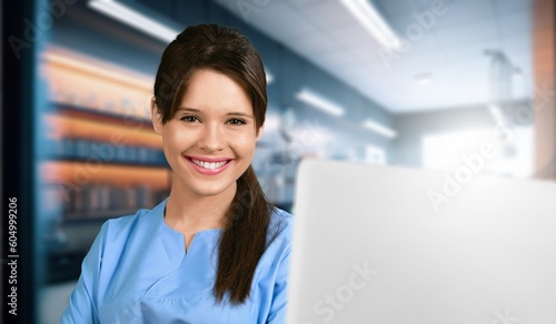 Young female doctor work on laptop computer