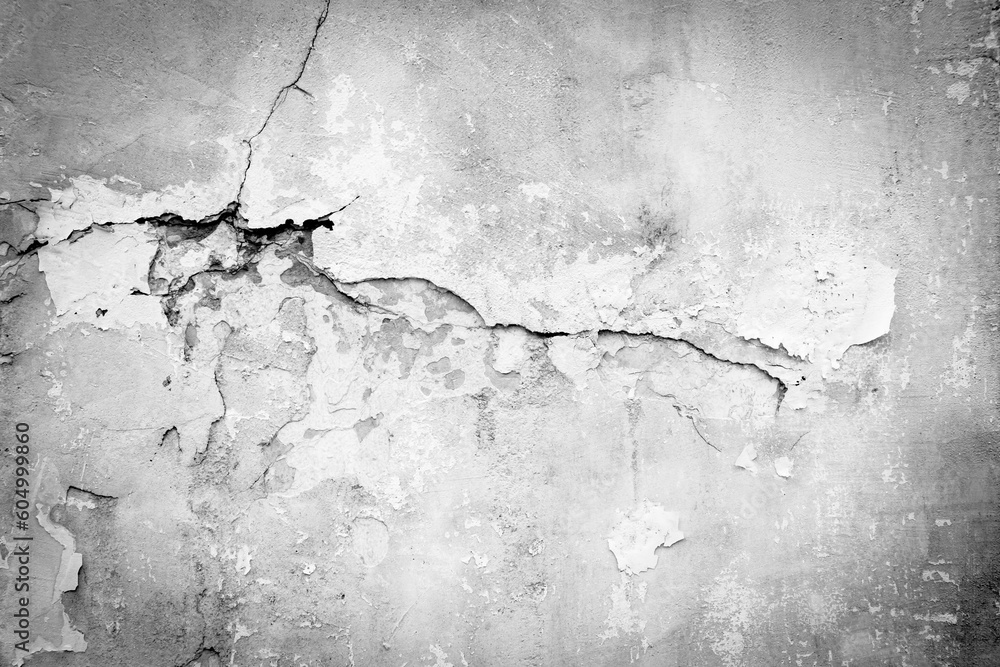 Old wall with deep cracks. Grunge gray color texture. Destruction on the surface of the wall.