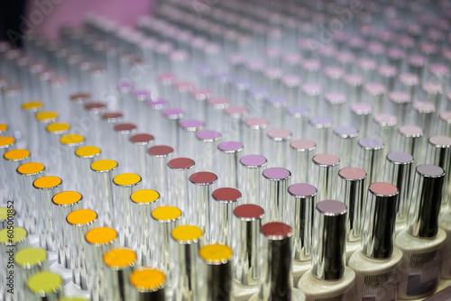 Set of colorful nail varnishes in row on counter of cosmetic shop - close up  selective focus. Fashion  cosmetic  beauty and glamour concept