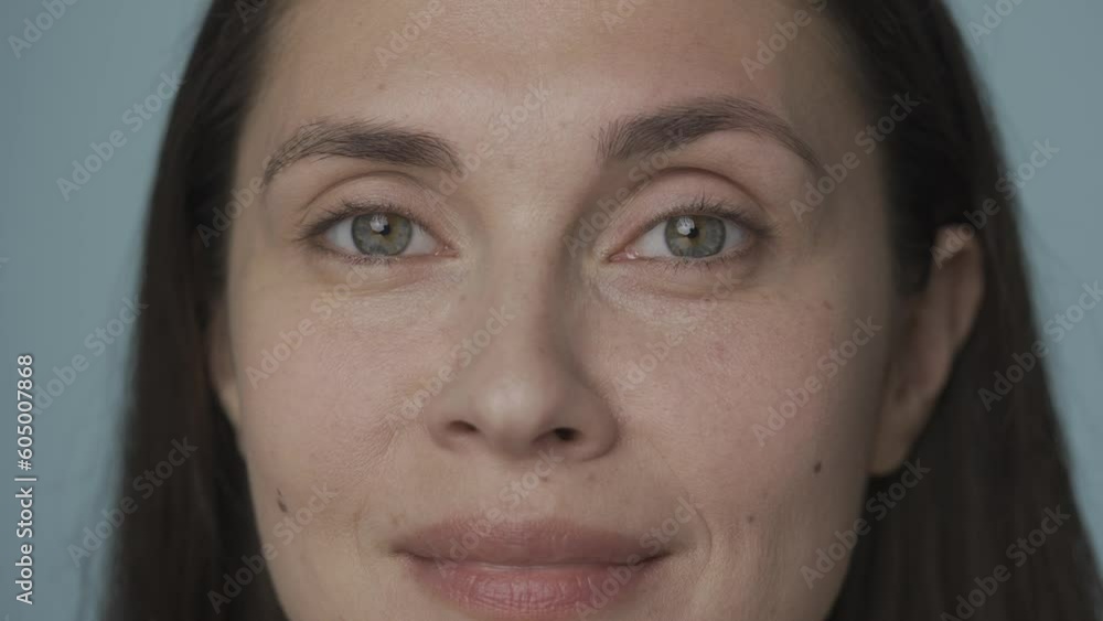 Beautiful eyes of a young woman. Close up of a woman's face with clean, healthy skin on a blue background. Good vision and eye care. Contact lenses. Natural female beauty. HDR BT2020 HLG Material. Beautiful eyes of a young woman. Close up of a woman's face with clean, healthy skin on a blue background. Good vision and eye care. Contact lenses. Natural female beauty. HDR BT2020 HLG Material.