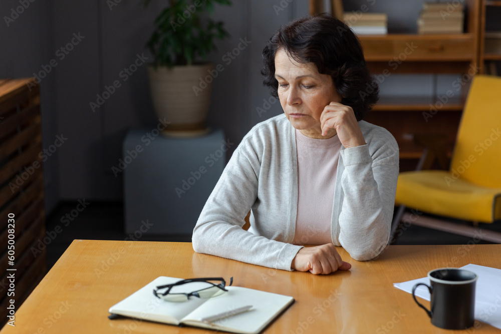 Sad tired ill sick lonely disappointed older senior woman sitting at home alone. Unhappy mature grandmother experiencing grief relative death bad news. Stressed elder lady suffering from loneliness Sad tired ill sick lonely disappointed older senior woman sitting at home alone. Unhappy mature grandmother experiencing grief relative death bad news. Stressed elder lady suffering from loneliness