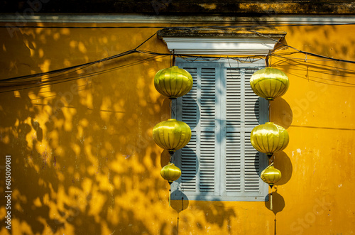 A typical traditional house in Vietnam Hoian with yellow wall, light blue window and yellow lanterns.