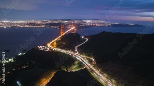 Drone timelapse Golden Gate Bridge San Francisco City at night illumination after sunset. Highway to Golden Gate Bridge Skyline hyperlapse. Beautiful aerial shot of San Francisco. Aerial city at night