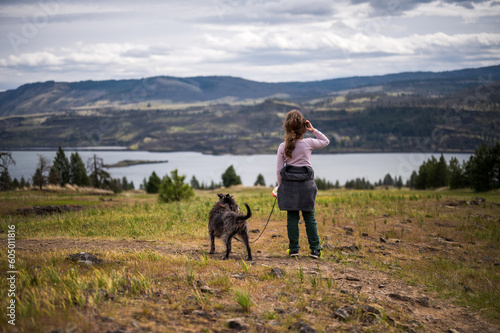 A girl and her dog in Washington overlook the Columbia River to Oregon © Robb