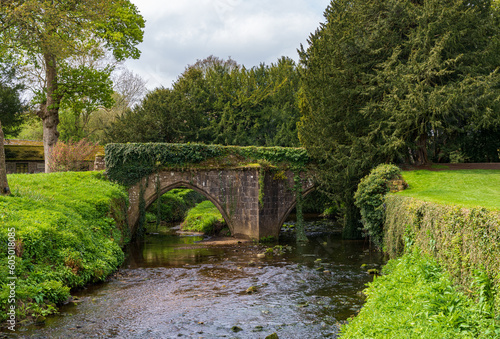 Detail of the stone bridge across River Skell among ruins of Fountains Abbey in Yorkshire, United Kingdom