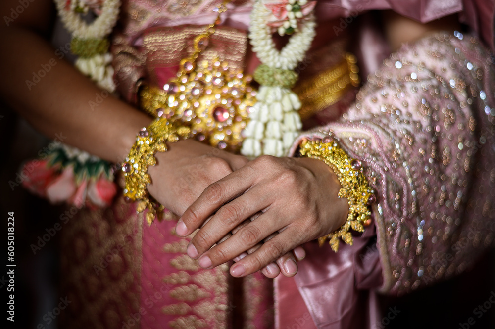 close up woman in Thai traditional dress bride costume with Gold jewelry in wedding ceremony