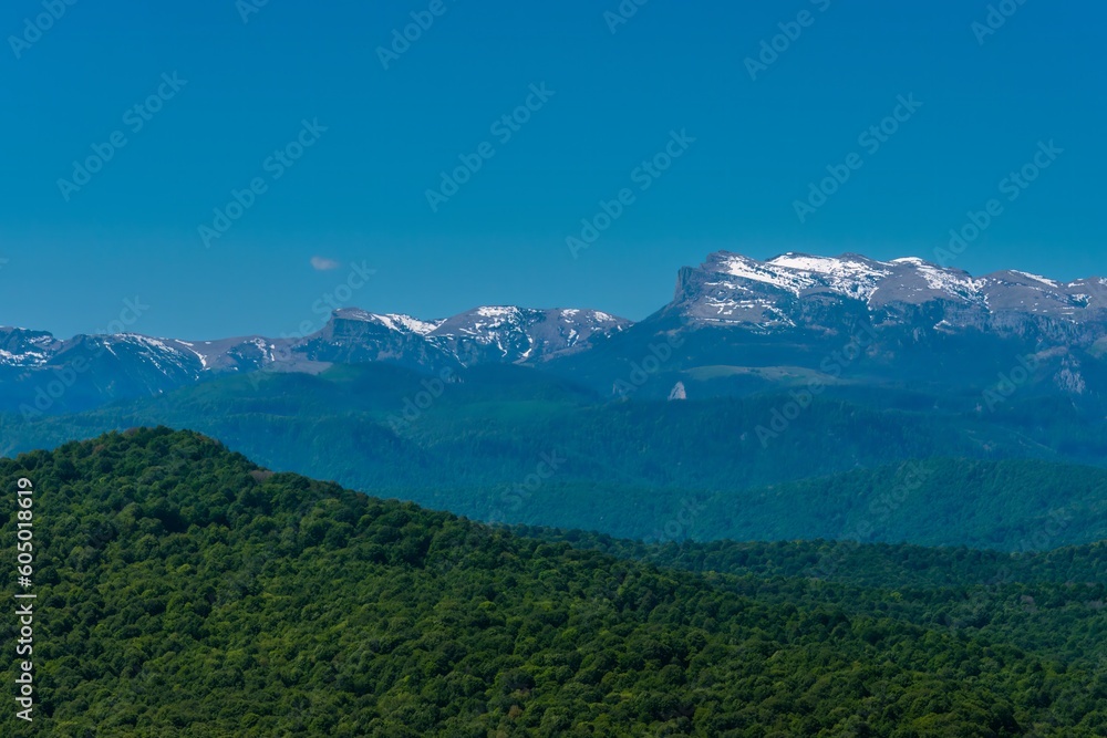 mountain peaks of the Main Caucasian Range from the side of the village of Bagovskaya (South of Russia) on a sunny summer day