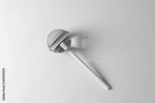 Round monochromatic lollipop candy with a stick on white background with shadow. Illustration of the concept of childhood and confectionary industry photo