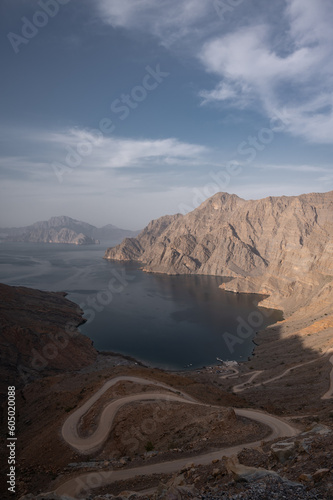 A view of Khor Najd in Musandam Oman, with a winding road down to the beach