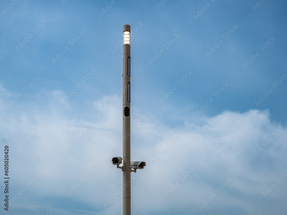Surveillance cameras on a pole against the sky. Surveillance cameras for the object. Surveillance cameras on a pole against the sky. Surveillance cameras for the object.
