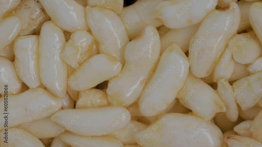 Top view: puffed honey rice grains on rotating surface - close up, macro. Oriental sweet, organic, gastronomy and Asian food concept Top view: puffed honey rice grains on rotating surface - close up, macro. Oriental sweet, organic, gastronomy and Asian food concept