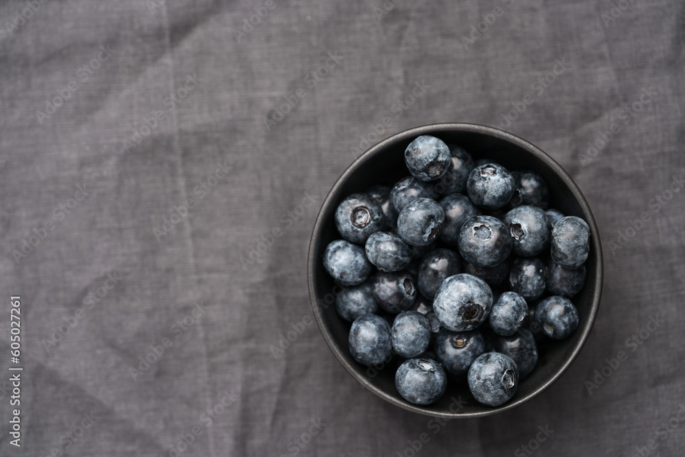 Freshly washed organic blueberries in a black bowl closeup Freshly washed organic blueberries in a black bowl closeup