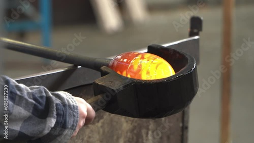 Craftsman Shaping a Ball of Molten Glass. Close Up.