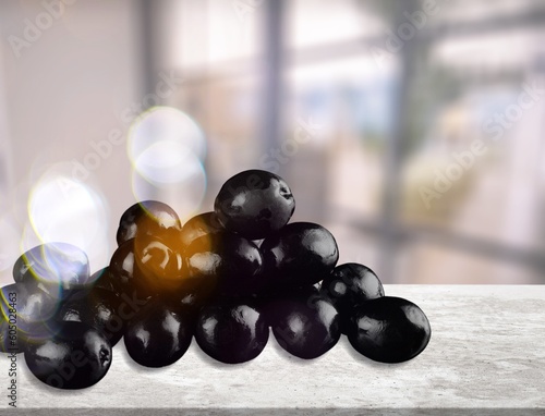 Black tasty olives on the desk in room