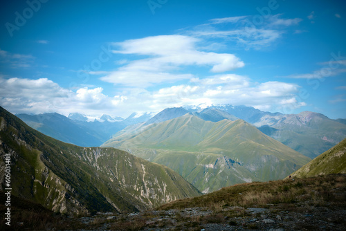 Mountain ranges on a sunny day at Georgia. Sky with clouds adn hills