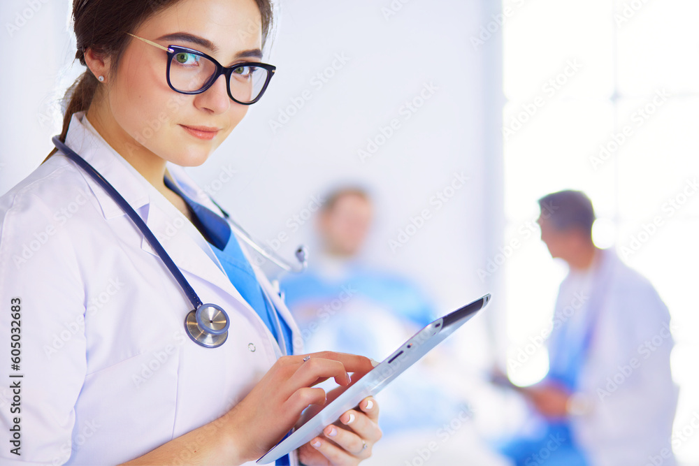 Female doctor using tablet computer in hospital lobby Female doctor using tablet computer in hospital lobby