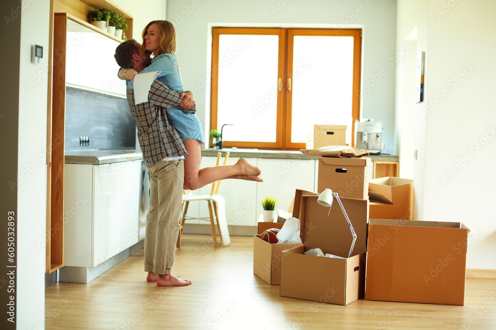 Portrait of young couple moving in new home. Young couple Portrait of young couple moving in new home. Young couple