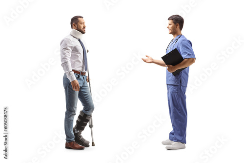 Full length profile shot of an injured man with a walking brace and cervical collar listening to a healthcare worker