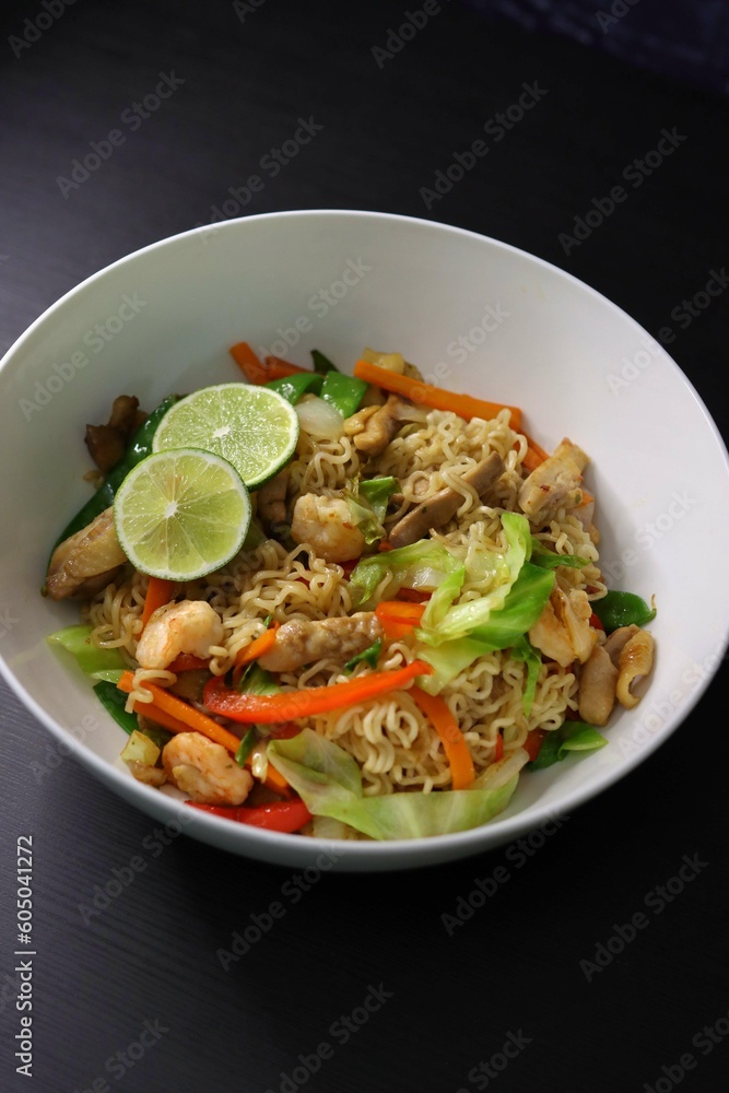 Pancit Canton Chow Mein Stir Fry Instant Noodles with Shrimp, Chicken, Cabbage, Carrots, Snow Peas, Red Peppers, Lime