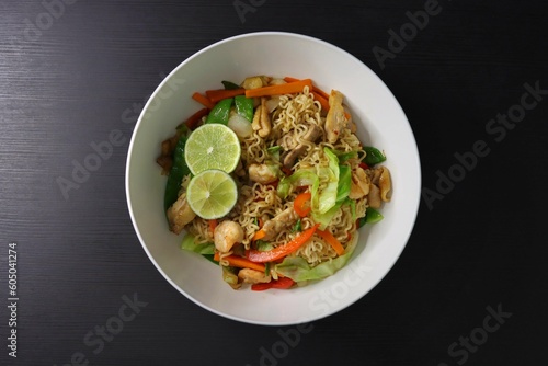 Pancit Canton Chow Mein Stir Fry Instant Noodles with Shrimp, Chicken, Cabbage, Carrots, Snow Peas, Red Peppers, Lime - Top Down View