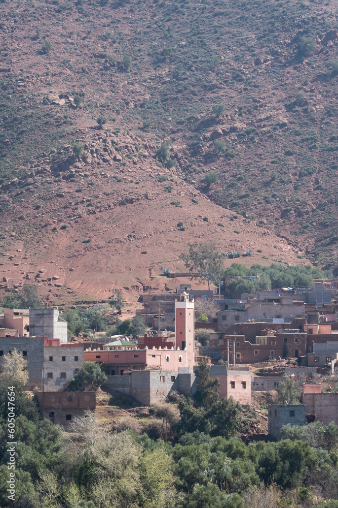 A town sits on the skirts of the mountains of the Ourika Valley in the High Atlas of Morocco