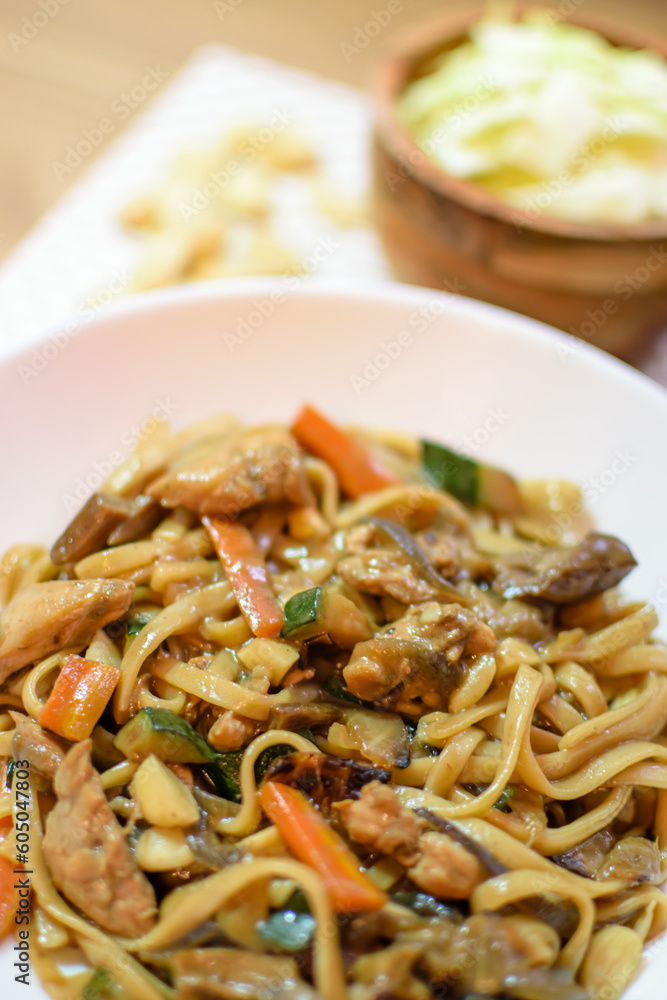 Rice noodles served with vegetables and meat in white bowl. Rice noodles served with vegetables and meat in white bowl.