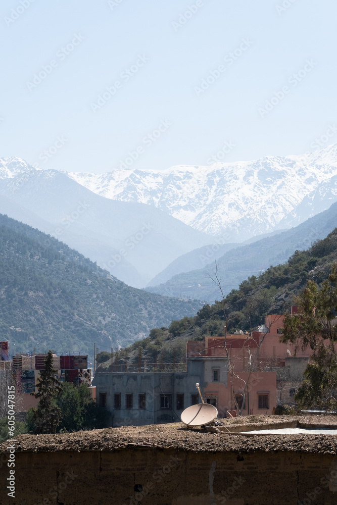 Landscape of the snow peak mountains of the Ourika Valley above a civilization in Morocco