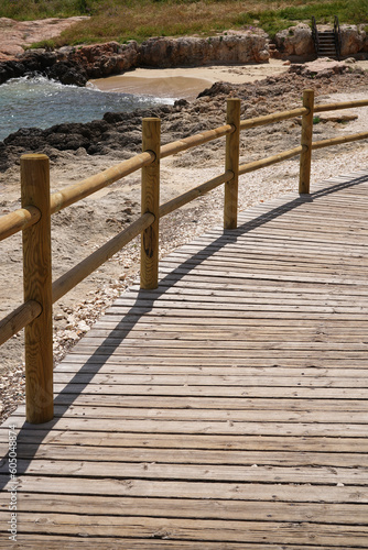wooden walkway to Cala Porto Bianco beach in picturesque Monopoli, Puglia, Italy