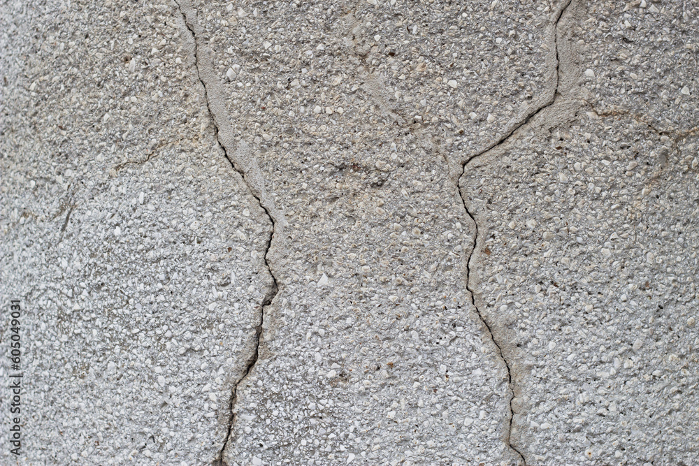 Obraz premium close up of grey cracked plaster wall surface 