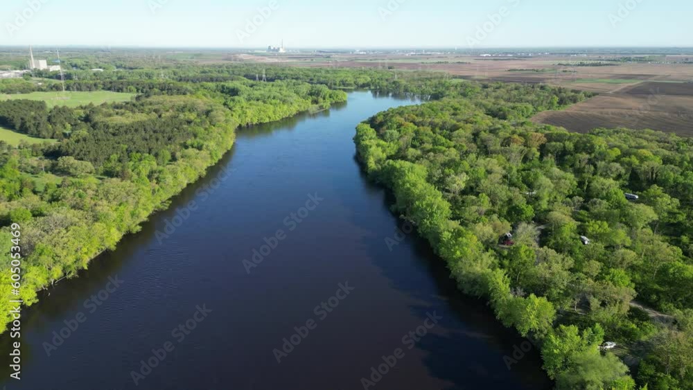 Blue River Surrounded By Green Forest and Aerial View of Trees Along Shoreline with Flowing Water Blue River Surrounded By Green Forest and Aerial View of Trees Along Shoreline with Flowing Water