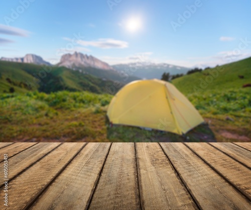 Wooden blank table top on camping tent background