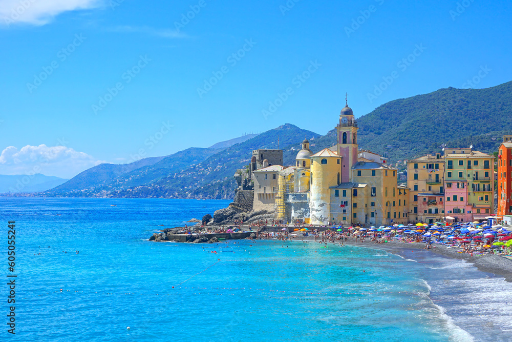 Colorful Mediterranean village of Camogli, Italy. View of the beach along the turquoise sea.