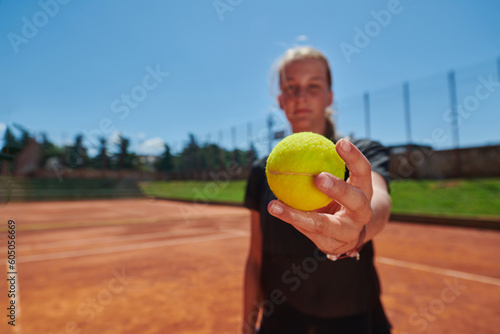 Before her training, the tennis player joyfully playing with a tennis ball, radiating enthusiasm and playfulness, as she prepares herself mentally and physically for the upcoming challenges on the © .shock