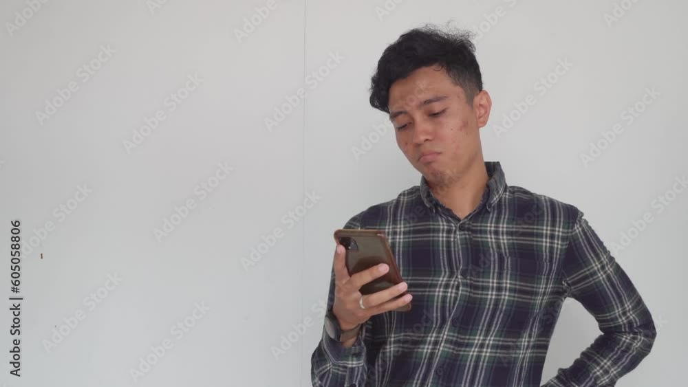 Young men Indonesian texting on the smartphone. The video is suitable to use for expression video promote and advertising. Young men Indonesian texting on the smartphone. The video is suitable to use for expression video promote and advertising.