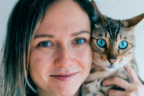 Canvas Print portrait of a girl and her bengal cat. Blue eyes