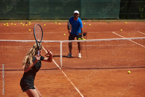 Quadro em tela A professional tennis player and her coach training on a sunny day at the tennis court