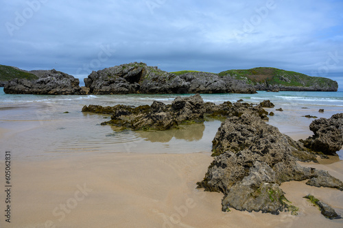 View on Playa de Borizo in Celorio, Green coast of Asturias, North Spain with sandy beaches, cliffs, hidden caves, green fields and mountains.