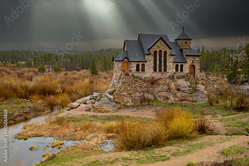 St. Catherine's of Siena Chapel on the Rock in Allenspark, CO, under rays of sun. 