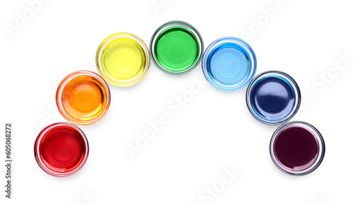 Glass bowls with different food coloring on white background  top view