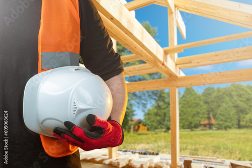 Hardhat in hand. Builder at...