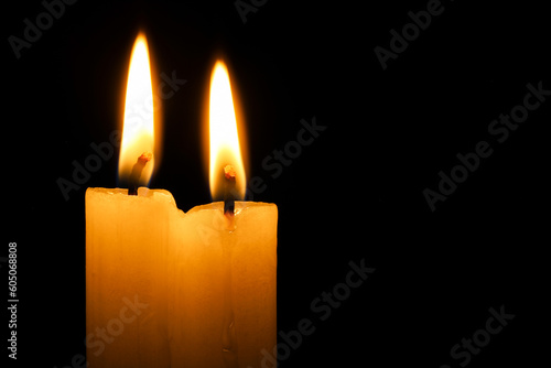 Burning candles on black background  closeup. Space for text