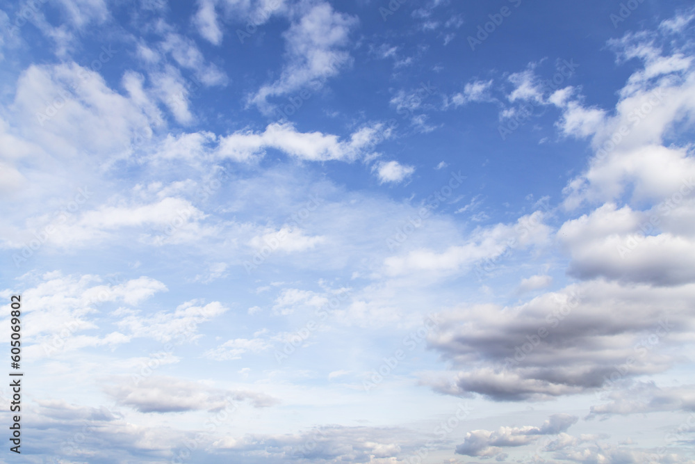 Beautiful blue sky with many white cirrus and fluffy clouds in sunlight, background texture, heaven Beautiful blue sky with many white cirrus and fluffy clouds in sunlight, background texture, heaven